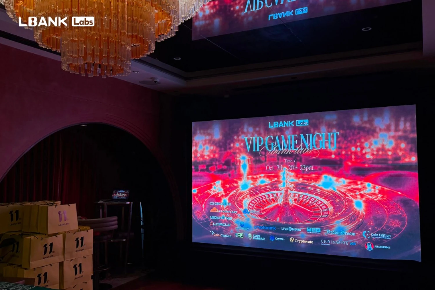 LBank Labs VIP Game Night screen with roulette visual and sponsor logos at TOKEN2049 Singapore